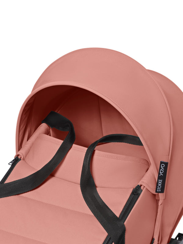 Alcofa STOKKE YOYO³ ultra leve e compacta, com colchão respirável, capota ventilada, cobre-pés, tecido impermeável com proteção UPF 50+ e compatível com o carrinho STOKKE YOYO³ para bebés desde o nascimento até aos 9 kg. Ginger