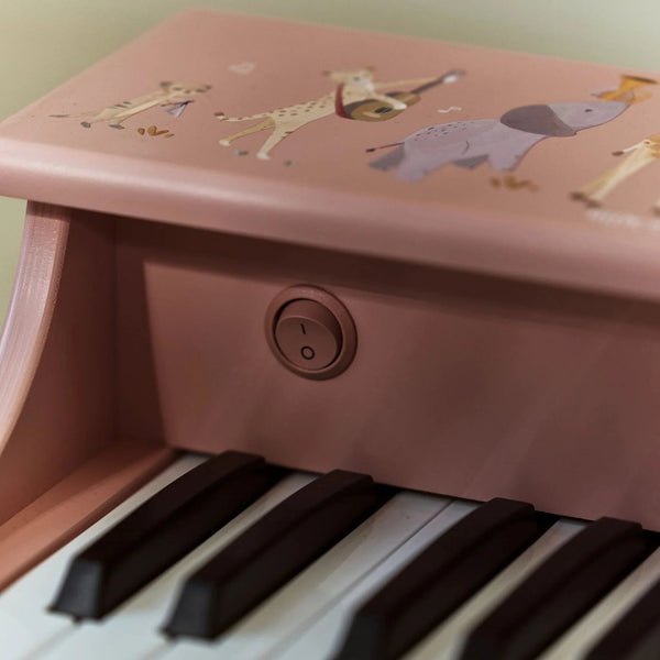Piano de madeira Safari Friends com 11 teclas e melodias integradas, ideal para estimular a criatividade, o ritmo e a iniciação musical das crianças rosa.